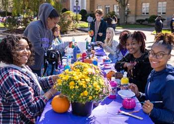 students painting pumpkins